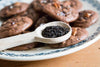 Lychee Black Schwartz Loser blatt Tee auf einem Holzlöffel neben Schokoladenkeksen - Lychee Black Loose-leaf Black Tea on wooden spoon next to chocolate cookies
