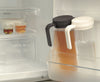 zwei hohe transparente Teekanne in der Kuhlschranktür - two tall transparent tea jugs in the fridge door